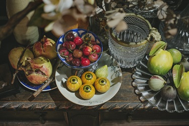 Fruits, glassware and a bowl of eyeballs on the mantle, Hat Factory